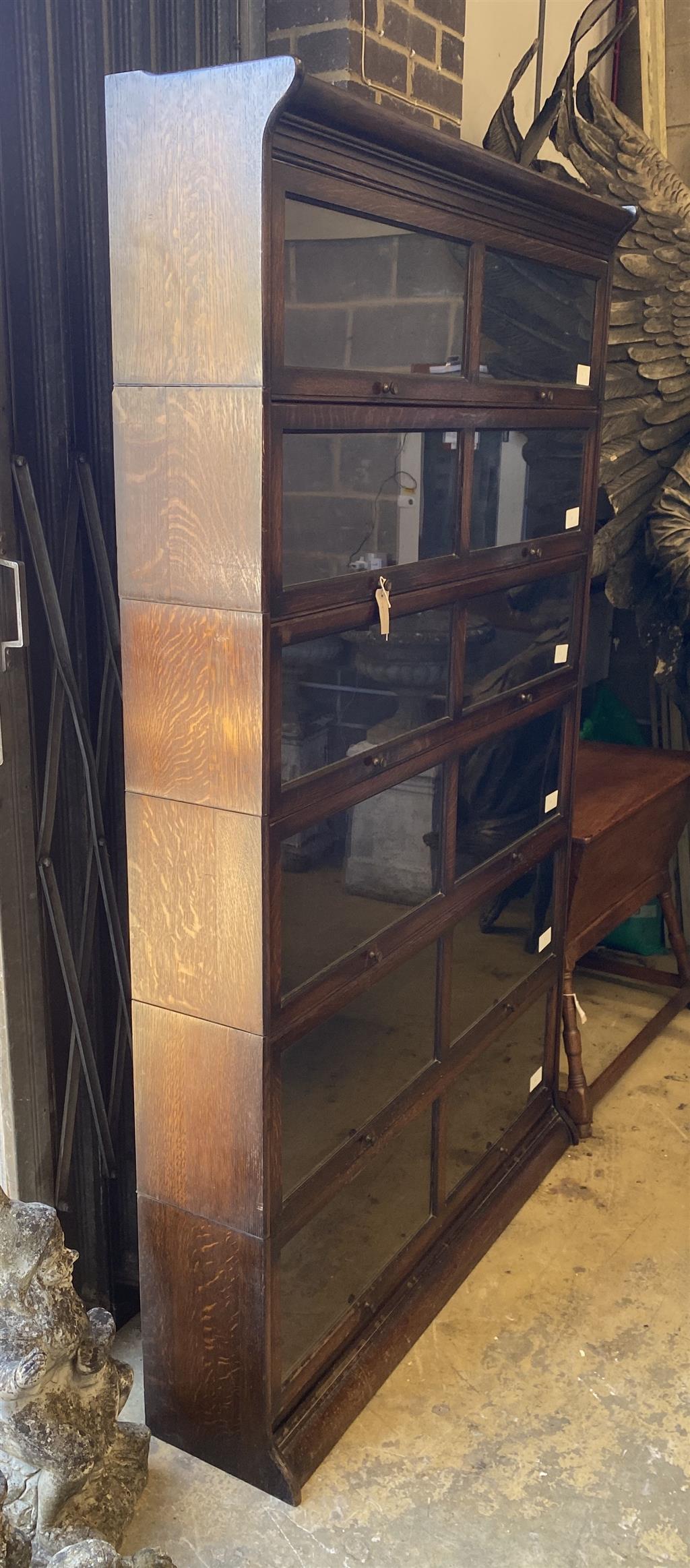 An early 20th century Gunn oak six section bookcase, length 126cm, depth 29cm, height 208cm